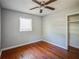 Clean bedroom with hardwood floors, a ceiling fan, and window for natural light at 503 W Lee St, Plant City, FL 33563