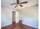 Bedroom with hardwood floors, ceiling fan, closet and hallway access to the house at 503 W Lee St, Plant City, FL 33563