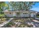 Charming single-story home featuring light grey siding and a well-maintained front yard at 503 W Lee St, Plant City, FL 33563