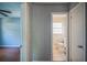 Hallway view showcases access to a brightly lit bathroom and hardwood floors at 503 W Lee St, Plant City, FL 33563