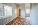 Cozy living room featuring unique tiled floors, wood walls, and bright, natural light at 503 W Lee St, Plant City, FL 33563