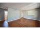 Open living room with hardwood floors and neutral paint, leading to the bathroom at 503 W Lee St, Plant City, FL 33563
