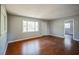 Spacious living room with hardwood flooring, large windows, and neutral walls at 503 W Lee St, Plant City, FL 33563