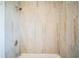 Clean bathtub and shower featuring light colored marble-look tiling at 503 W Lee St, Plant City, FL 33563