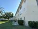 Multi-story condo exterior with well-maintained landscaping and mature trees at 5750 80Th N St # B203, St Petersburg, FL 33709