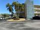 Low-rise condo building with well-maintained grounds, mature palm trees, and convenient parking at 5750 80Th N St # B203, St Petersburg, FL 33709