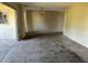 Spacious living room with view to kitchen featuring a chandelier and wall-to-wall carpeting at 5750 80Th N St # B203, St Petersburg, FL 33709
