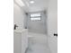 Modern bathroom features a shower-over-tub with marble-look tile and black fixtures at 7227 Otter Creek Dr, New Port Richey, FL 34655