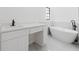 Modern bathroom featuring a soaking tub, vanity, and marble floors at 7227 Otter Creek Dr, New Port Richey, FL 34655