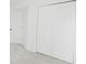 Carpeted bedroom with closet and door at 7227 Otter Creek Dr, New Port Richey, FL 34655