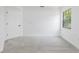 Carpeted bedroom with window and door at 7227 Otter Creek Dr, New Port Richey, FL 34655