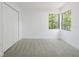 Carpeted bedroom featuring large window and closet at 7227 Otter Creek Dr, New Port Richey, FL 34655