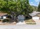 Charming single-Gathering home with mature trees, a paved driveway, and attached two-car garage at 7227 Otter Creek Dr, New Port Richey, FL 34655