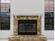Close up of the stone fireplace flanked by windows at 7227 Otter Creek Dr, New Port Richey, FL 34655