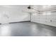 Clean two-car garage with painted floor and walls, featuring a garage door opener and side entry door at 7227 Otter Creek Dr, New Port Richey, FL 34655