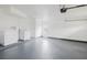Clean two-car garage featuring painted floor and walls plus new washer and dryer hook-ups at 7227 Otter Creek Dr, New Port Richey, FL 34655