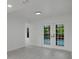 Bright living room featuring double doors offering a glimpse of the pool, fresh paint and luxury vinyl flooring at 7227 Otter Creek Dr, New Port Richey, FL 34655
