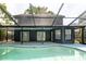 View of home exterior from pool showcasing ample room for outdoor entertaining and relaxing at 7227 Otter Creek Dr, New Port Richey, FL 34655