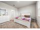 Carpeted bedroom features a white bed frame, dresser, and natural light from the window at 7334 Ashcroft Dr, Wesley Chapel, FL 33545