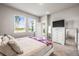 Well-lit bedroom with carpet, white furniture, and a view from the windows at 7334 Ashcroft Dr, Wesley Chapel, FL 33545