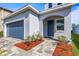 Charming two-story home with manicured lawn, a paved driveway, and attached garage in a quiet neighborhood at 7334 Ashcroft Dr, Wesley Chapel, FL 33545