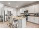 Well-lit kitchen featuring stainless steel appliances, granite counters, and a large island with seating at 7334 Ashcroft Dr, Wesley Chapel, FL 33545