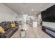 Open-concept living room flows into a kitchen with modern appliances and a dining area, perfect for entertaining at 7334 Ashcroft Dr, Wesley Chapel, FL 33545