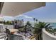 Relaxing balcony with seating offers water views with palm trees at 80 Rogers St # 2A, Clearwater, FL 33756