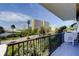 Relax on the balcony with a view of lush greenery, palm trees, and nearby high-rise buildings at 80 Rogers St # 2A, Clearwater, FL 33756