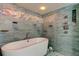 Featuring a standalone tub with decorative mosaic tile and modern shower fixture at 80 Rogers St # 2A, Clearwater, FL 33756