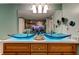 Bathroom with dual vessel sinks, wooden cabinetry, and large decorative mirror at 80 Rogers St # 2A, Clearwater, FL 33756