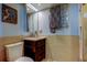 Charming bathroom with vanity, patterned vessel sink, mirror, and wall decor at 80 Rogers St # 2A, Clearwater, FL 33756