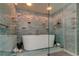 Featuring a standalone tub with decorative mosaic tile and modern shower fixture at 80 Rogers St # 2A, Clearwater, FL 33756