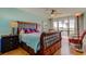 Bedroom with a stunning view, dark wood accents and ceiling fan at 80 Rogers St # 2A, Clearwater, FL 33756