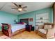 Cozy bedroom featuring a rattan bed, accent chair and coastal decor at 80 Rogers St # 2A, Clearwater, FL 33756