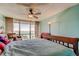 Bright bedroom features a ceiling fan, waterfront view and large windows at 80 Rogers St # 2A, Clearwater, FL 33756