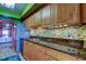 Stylish kitchen with granite counters, unique mosaic backsplash and stainless steel appliances at 80 Rogers St # 2A, Clearwater, FL 33756
