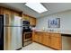 Modern kitchen featuring stainless steel appliances and wood cabinetry at 80 Rogers St # 2A, Clearwater, FL 33756