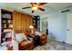 Cozy living room features built-in bookcase, storage, two armchairs, and a ceiling fan at 80 Rogers St # 2A, Clearwater, FL 33756