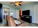 Comfortable living room features a ceiling fan, an armchair, and a TV at 80 Rogers St # 2A, Clearwater, FL 33756