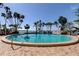 Enjoy a relaxing swim in the circular pool surrounded by lush landscaping and waterfront views at 80 Rogers St # 2A, Clearwater, FL 33756