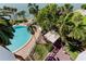 Aerial view of pool and outdoor entertaining area featuring poolside seating and waterfront views at 80 Rogers St # 2A, Clearwater, FL 33756