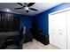Dark bedroom features blue walls, a ceiling fan, closet, and window with dark curtains at 9980 Sago Point Dr, Seminole, FL 33777