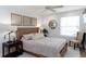 Comfortable bedroom featuring carpeted floors, modern decor, and a window with natural light at 9980 Sago Point Dr, Seminole, FL 33777