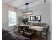 Dining room with modern lighting, large window and a view to the rear garden at 9980 Sago Point Dr, Seminole, FL 33777