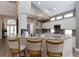 Bright kitchen with white cabinetry, granite countertops, bar seating and modern appliances at 9980 Sago Point Dr, Seminole, FL 33777