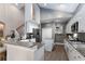 Well-appointed kitchen boasting white cabinetry, granite countertops, a kitchen island and modern appliances at 9980 Sago Point Dr, Seminole, FL 33777