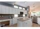 Charming kitchen featuring white cabinetry, granite countertops, kitchen island, and modern stainless steel appliances at 9980 Sago Point Dr, Seminole, FL 33777