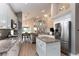 Open-concept kitchen with white cabinetry, granite countertops, stainless steel appliances and abundant natural light at 9980 Sago Point Dr, Seminole, FL 33777