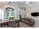 Stylish living room adjacent to dining area, featuring backyard views and access at 9980 Sago Point Dr, Seminole, FL 33777
